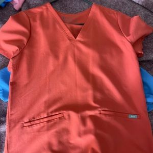 Color is called clay figs scrub top three pocket  size medium